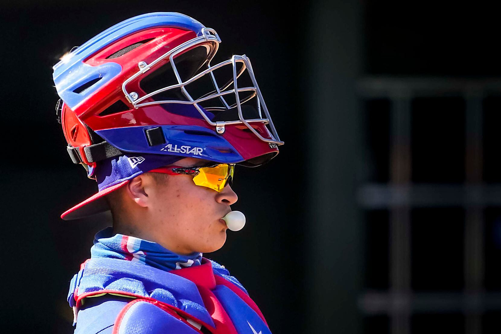 Texas Rangers catcher David Garcia blows a bubble between pitches during the sixth inning of...