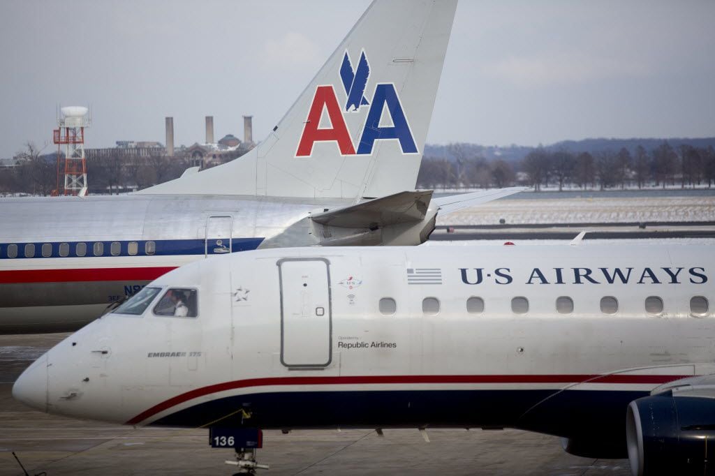 An American Airlines Group Inc. US Airways Group Inc. plane is pushed from a gate in front...