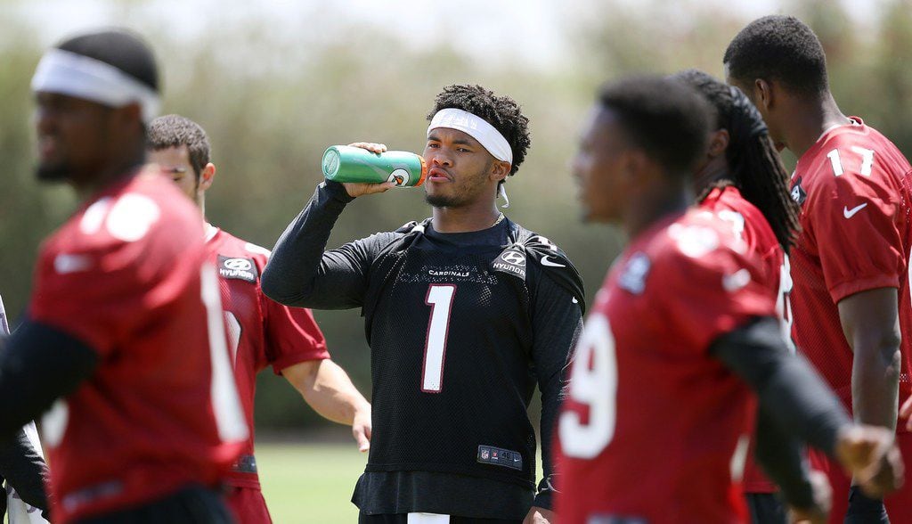 Arizona Cardinals rookie quarterback Kyler Murray takes a drink after stretching out prior to running drills at the team's NFL football training facility, Wednesday, June 12, 2019, in Tempe, Ariz. (AP Photo/Ross D. Franklin)
