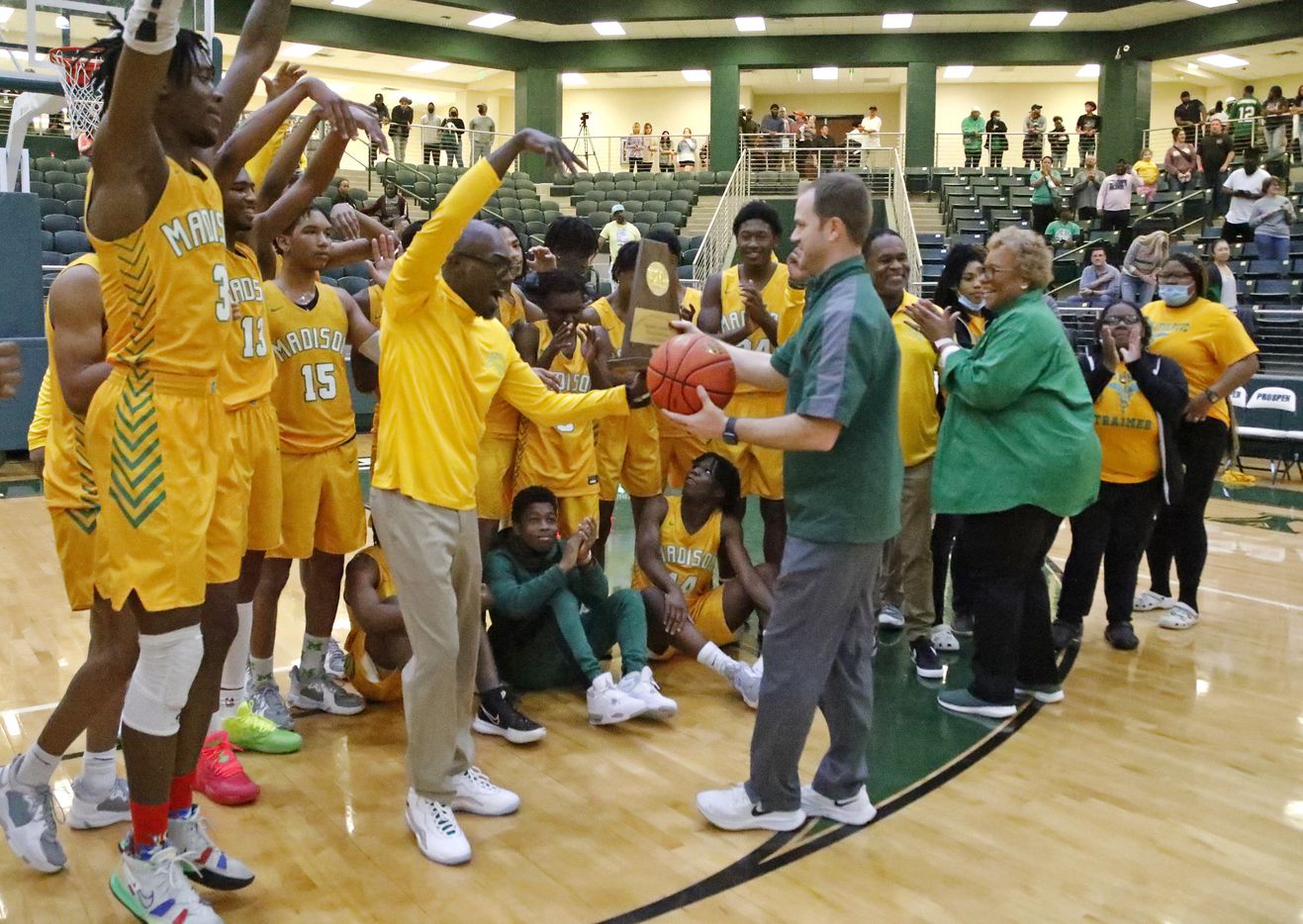 Madison head coach Damien Mobley receives the trophy and game ball after his victory in the...