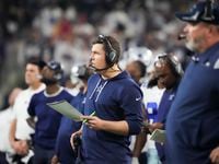 Dallas Cowboys offensive coordinator Kellen Moore works on the sidelines during the second half of an NFL Wild Card playoff football game against the San Francisco 49ers at AT&T Stadium on Sunday, Jan. 16, 2022, in Arlington.