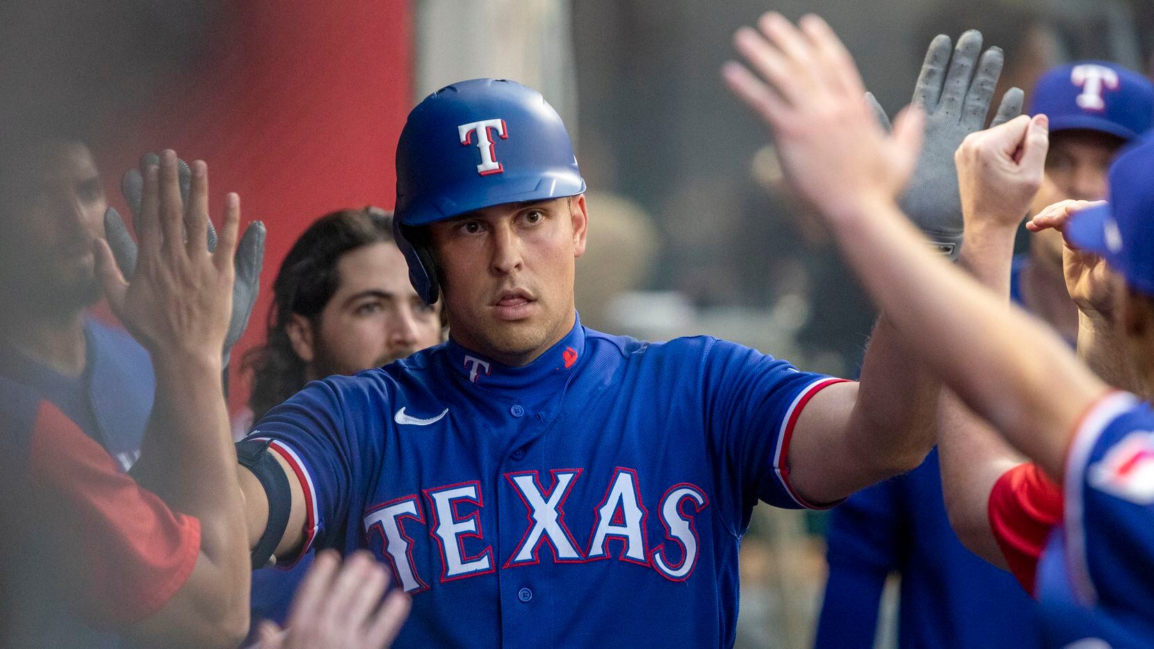 Texas Rangers' Nathaniel Lowe is congratulated by teammates after his solo home run against...