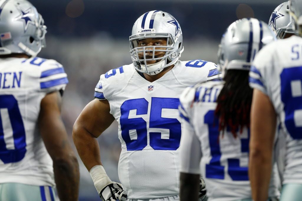 Dallas Cowboys guard Ronald Leary (65) waits in the huddle for a timeout to end against the...