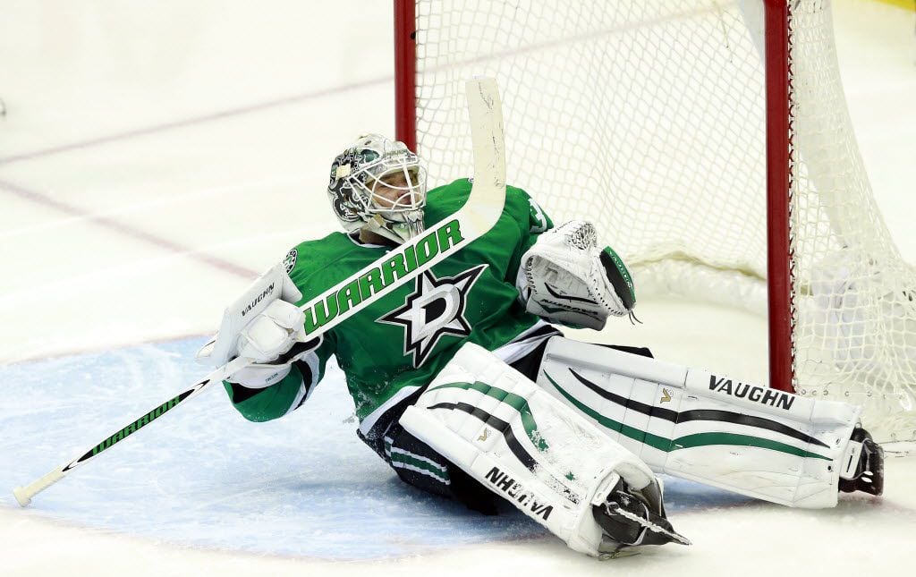 Dallas Stars goalie Antti Niemi (31) ended up on his back after being scored on by Minnesota...