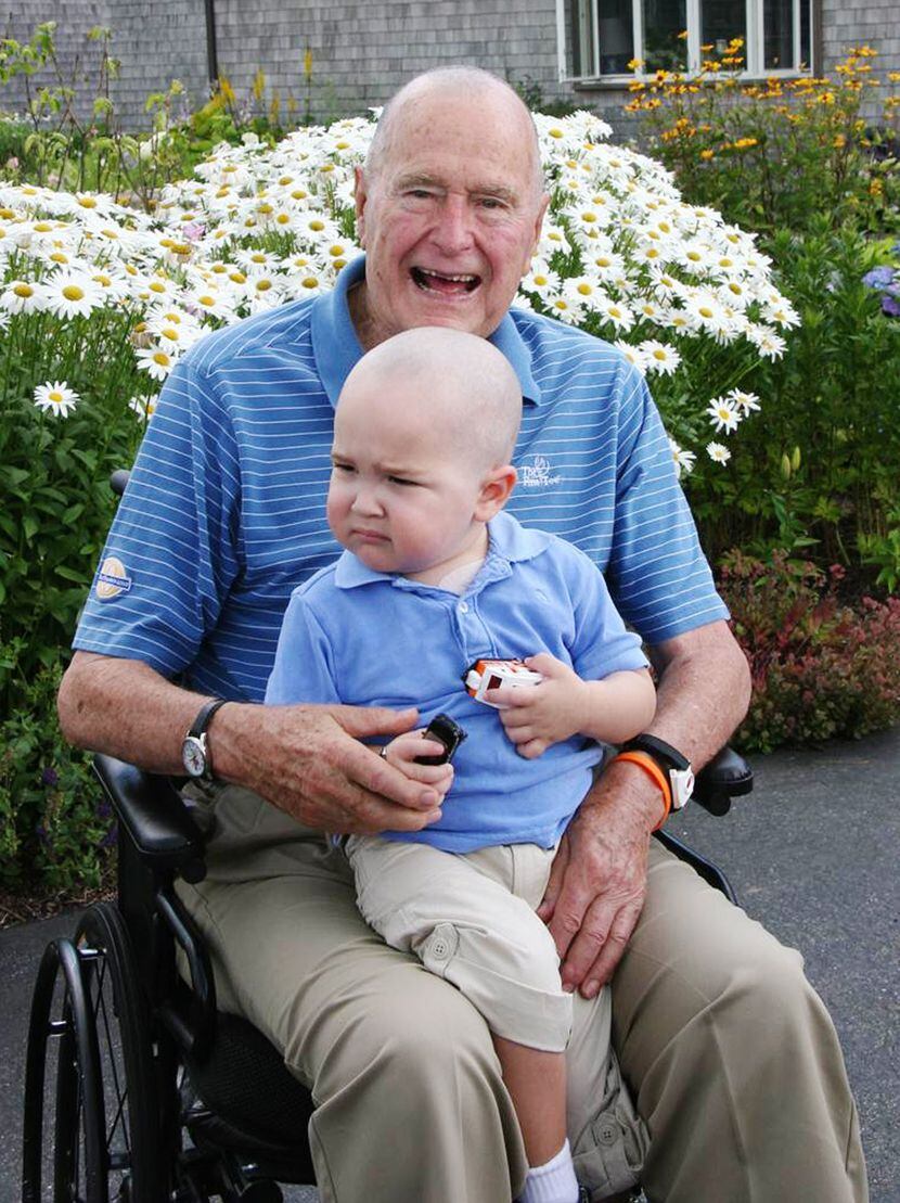 2013: President George H. W. Bush poses for a photo with his young friend Patrick (last name...