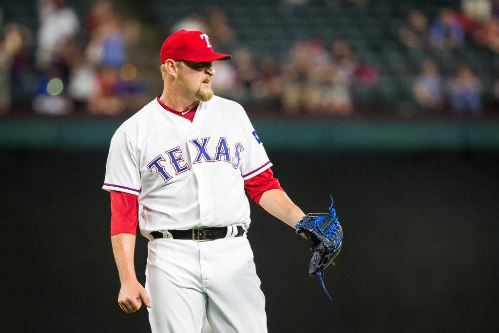 Texas Rangers pitcher Austin Bibens-Dirkx reacts after recording the final out of the ninth...