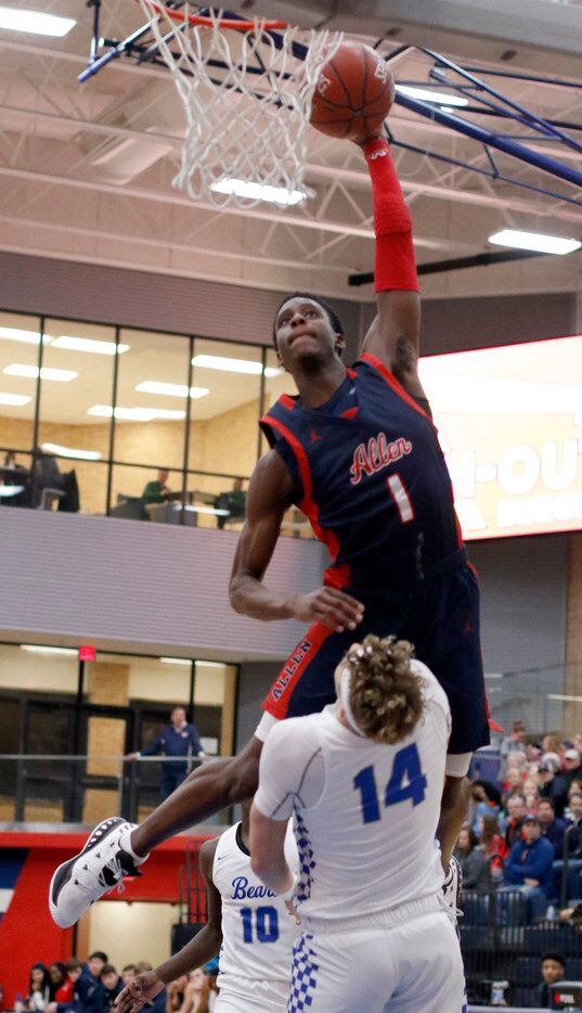 Allen's Manny Obaseki (1) skies to the basket as Fort Worth Brewer's Adam Duncan (14) holds...