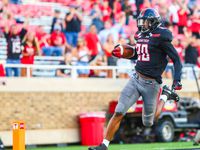 Texas Tech's Adrian Frye (20) returns an interception for a touchdown during an NCAA college...