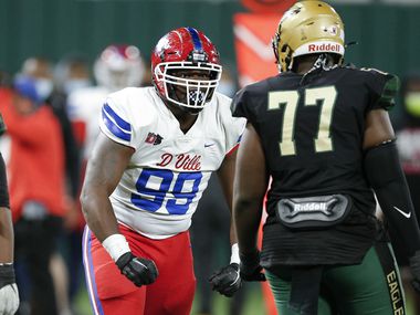 DeSoto junior guard Joshua Straw (77) looks on as Duncanville junior defensive tackle Quincy Wright (99) celebrates a sack during the first half of a Class 6A Division I Region II final high school football game, Saturday, January 2, 2021.