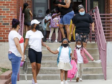 Parents pick up their children after school at Paul L. Dunbar Learning Center on Wednesday, Sept. 8, 2021, in Dallas. (Elias Valverde II/The Dallas Morning News)