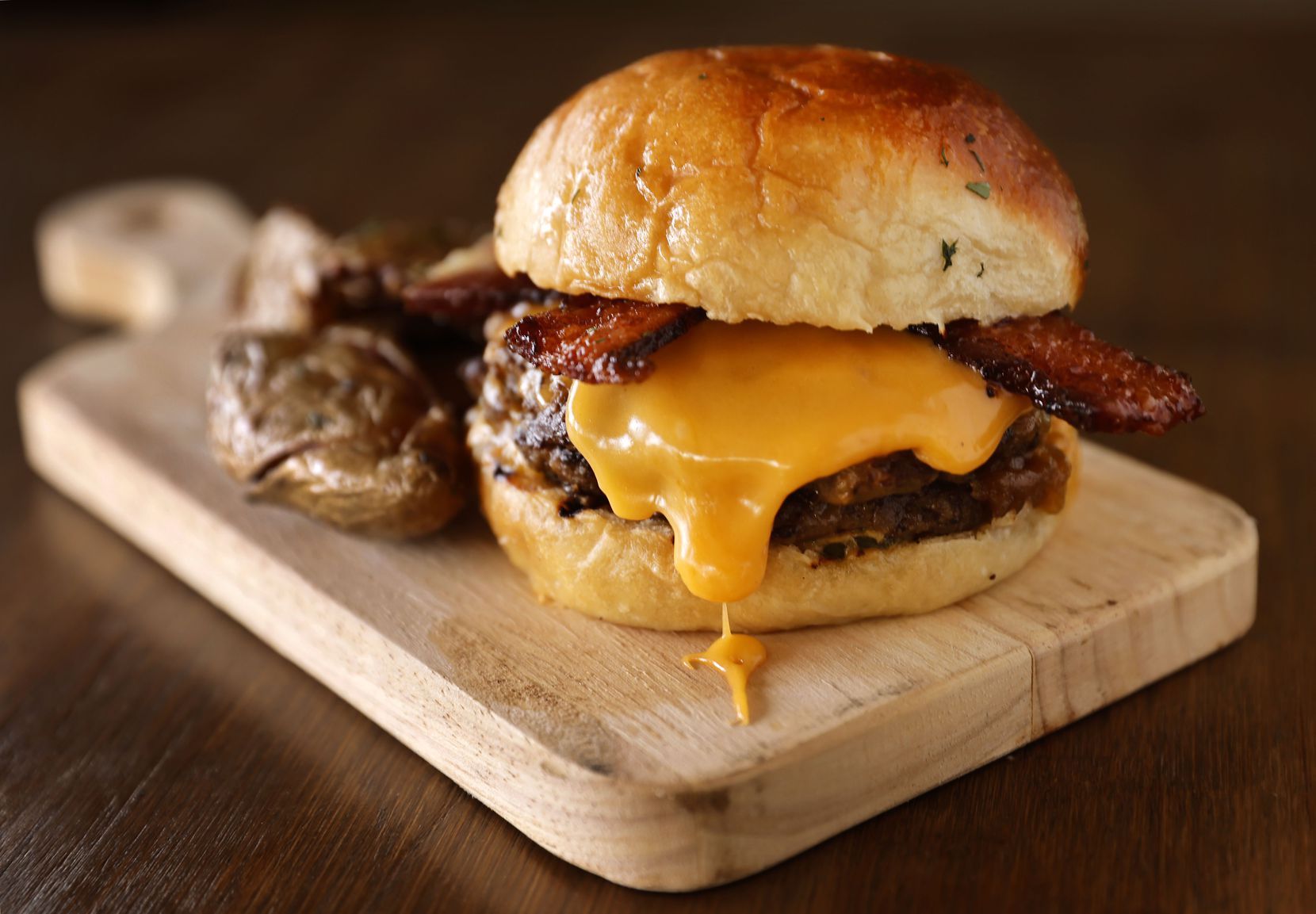 The Main Street Burger, with IPA cheddar and bacon, is one of the most popular items at The...