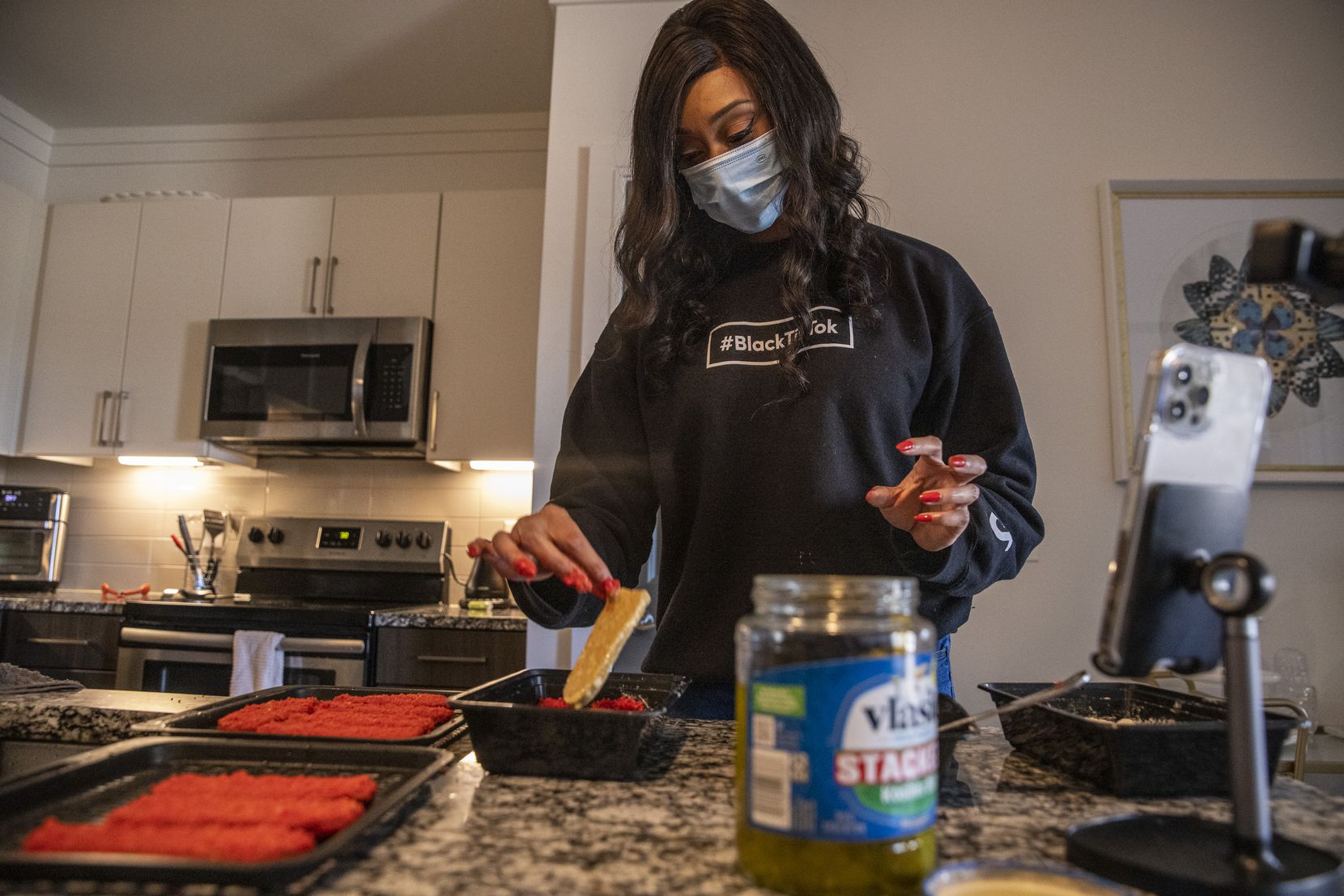 NaTasha Peck, creator of the YouTube channel ToshPointFro, creates Hot Cheetos fried pickle slices at her home in Frisco.