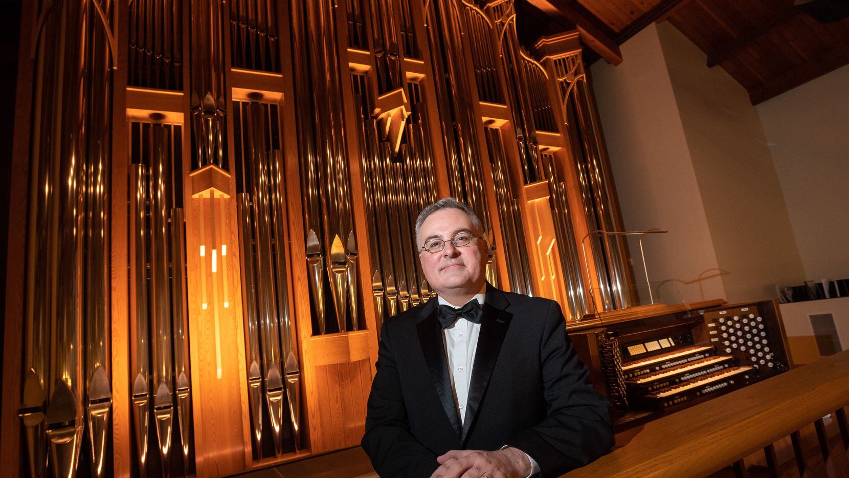 Organist Jeremy David Tarrant with the organ inside the Chapel on the campus of St. Mark's...