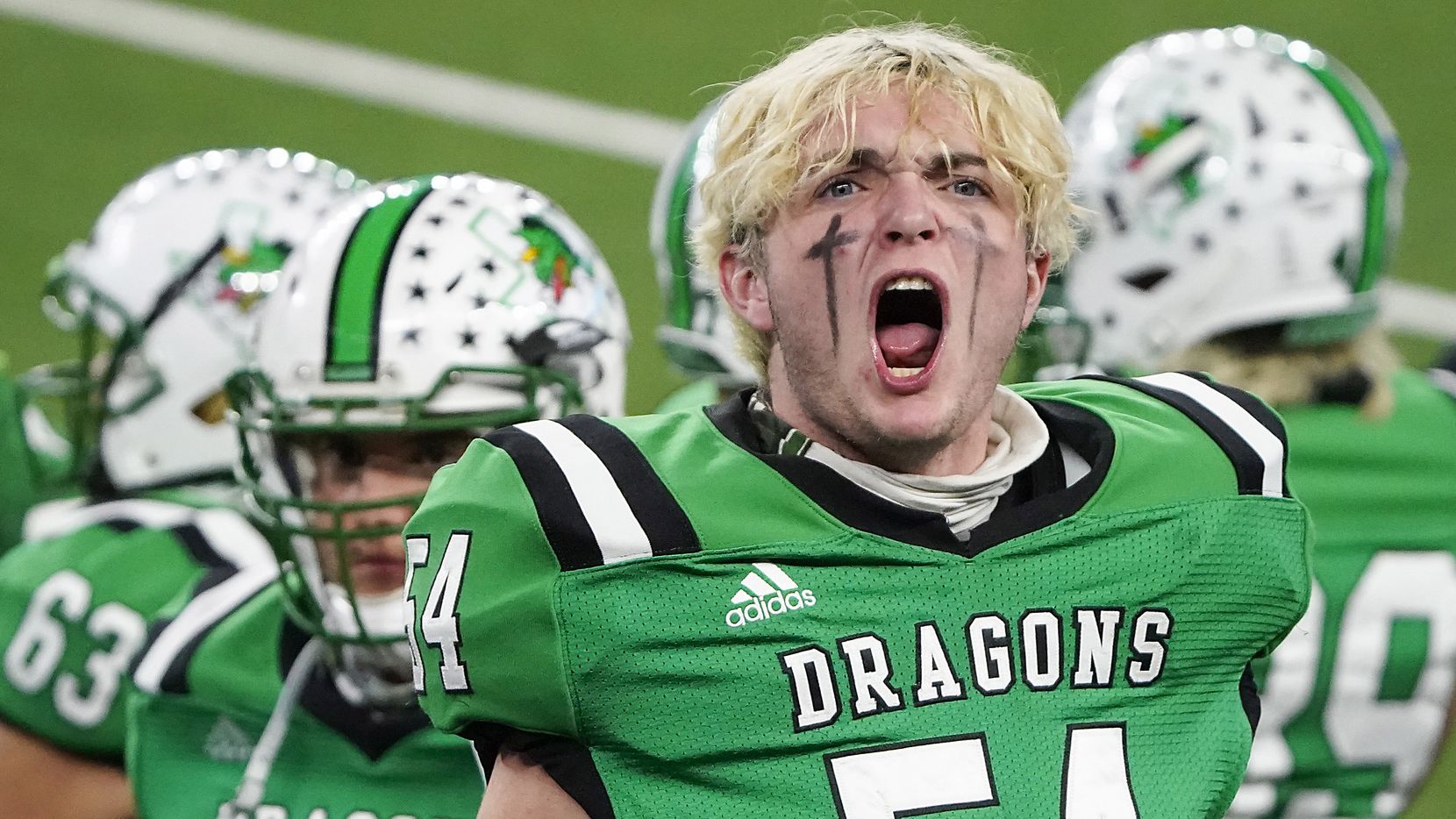 Southlake Carroll defensive lineman Jim Cates (54) yells to try and fire up the crowd during...