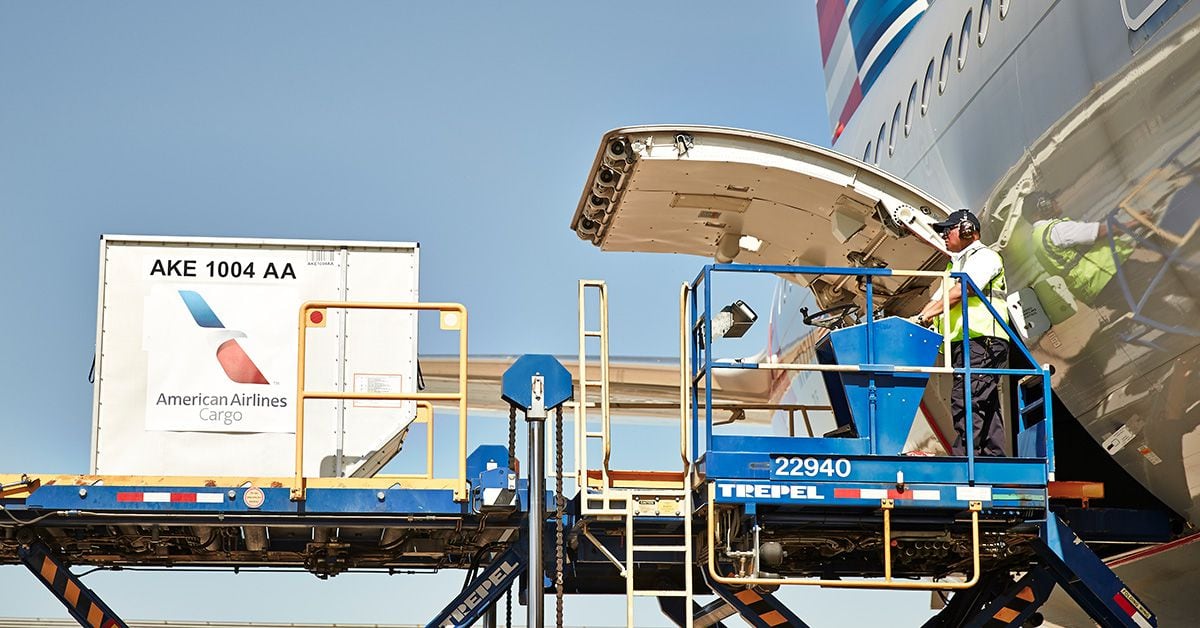An American Airlines employee loads cargo onto a jet. American has been steadily increasing its cargo-only deliveries since March, when it launched the flights for the first time in decades.