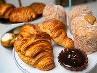 Pastries, including croissants, chocolate caramel tart and churro cruffins, are offered at...