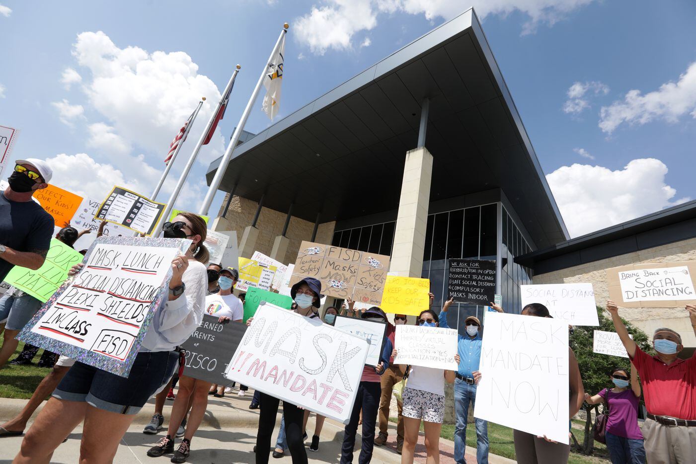 Community members seeking better COVID-19 protections gather during a protest at the Frisco ISD Administration Building in Frisco, TX, on Aug. 26, 2021.