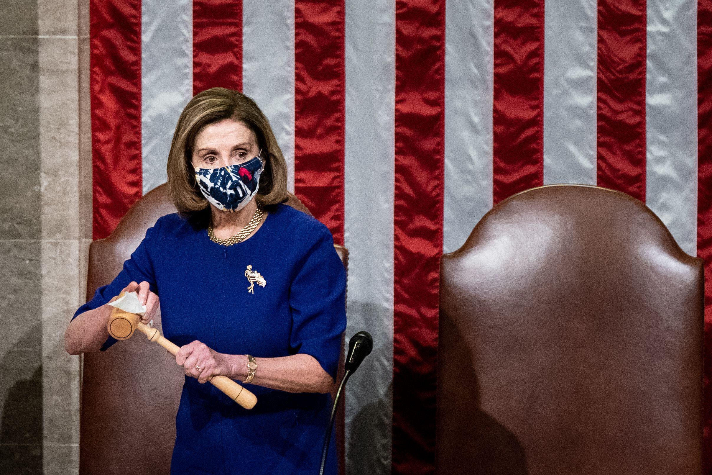 House Speaker Nancy Pelosi sanitizes the gavel after Vice President Mike Pence walked off...