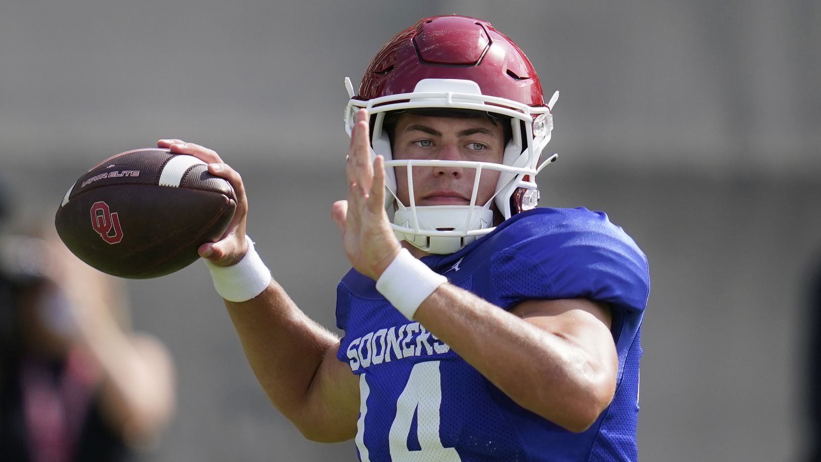 Oklahoma quarterback General Booty throws during an NCAA college football practice, Monday,...
