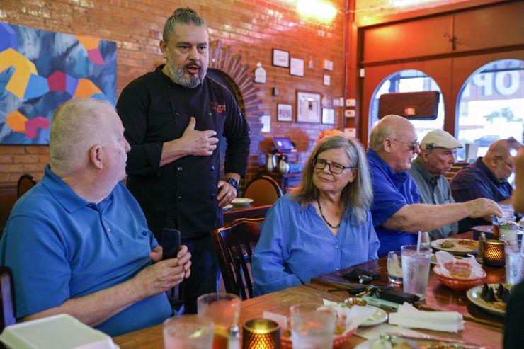 Owner and chef José Luis Rodriguez talks with Steve Harris (left) and Christie Grothe during...