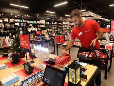 Sab Mirzaei stocked a seasonal items table Tuesday in the Amazon 4-Star store at Stonebriar Centre in Frisco.