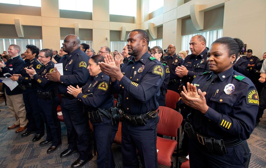 Dallas police officers give a standing ovation as officer Crystal Almeida, not pictured, receives the Theodore Roosevelt Police Award on Thursday, April 11, 2019 at the Jack Evans Police Headquarters in Dallas. Almeida was shot in the face while making an arrest last year at a Home Depot - an incident in which her partner, Rogelio Santander, was shot and killed. (Jeffrey McWhorter/Special Contributor)