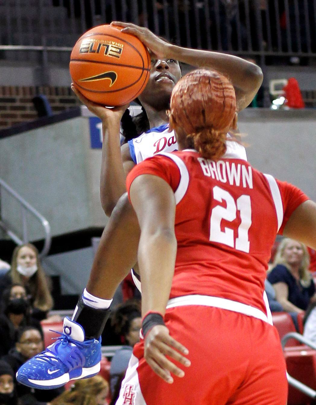 SMU guard Kayla White (32) gets off a jump shot over the defense of Houston guard Kendall...