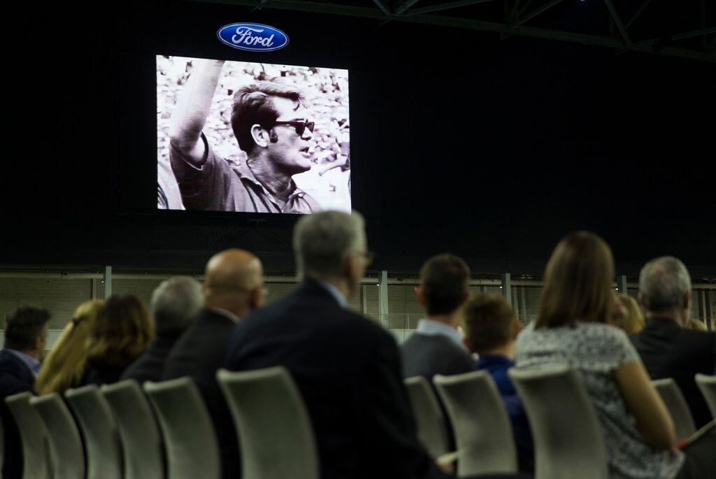 Family members watch a video tribute during a celebration of life service for Hayden Fry,...