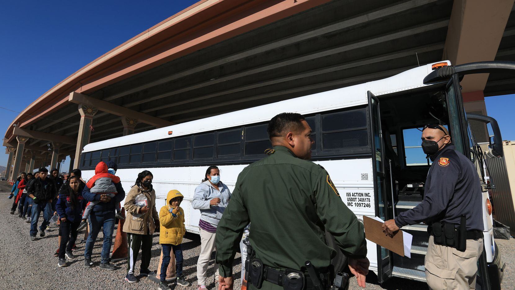 Migrants turn themselves into U.S. immigration authorities on Nov. 17 in El Paso.