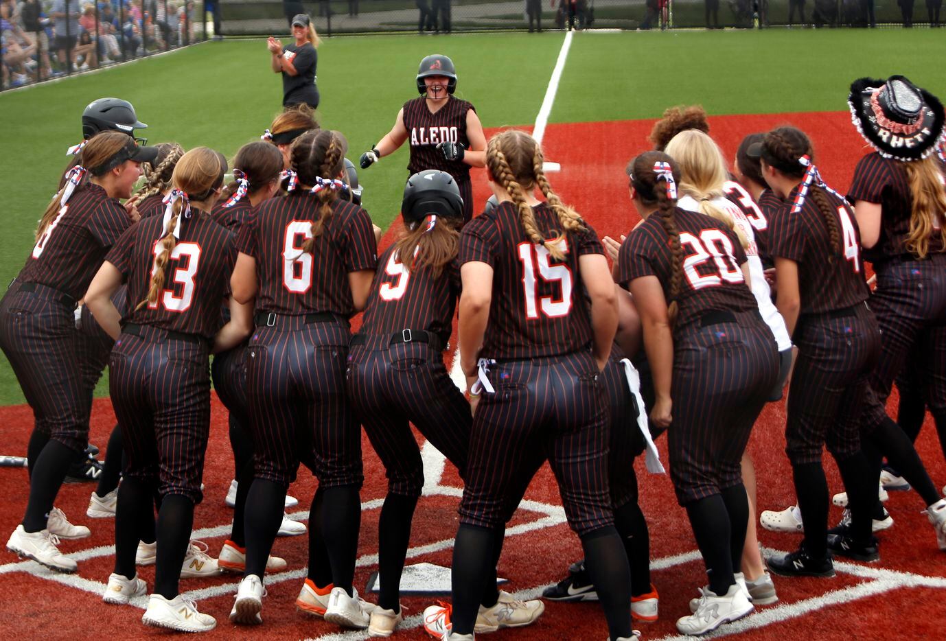 Aledo outfielder Marissa Powell (11) received quite the warm welcome from teammates gathered at home plate after swinging for the fences and accomplishing her goal with a 3-run homer during the top of the 4th inning of play against Georgetown. The two teams played their UIL 5A state softball semifinal game at Leander Glenn High School in Leander on June 4, 2021. (Steve Hamm/ Special Contributor)