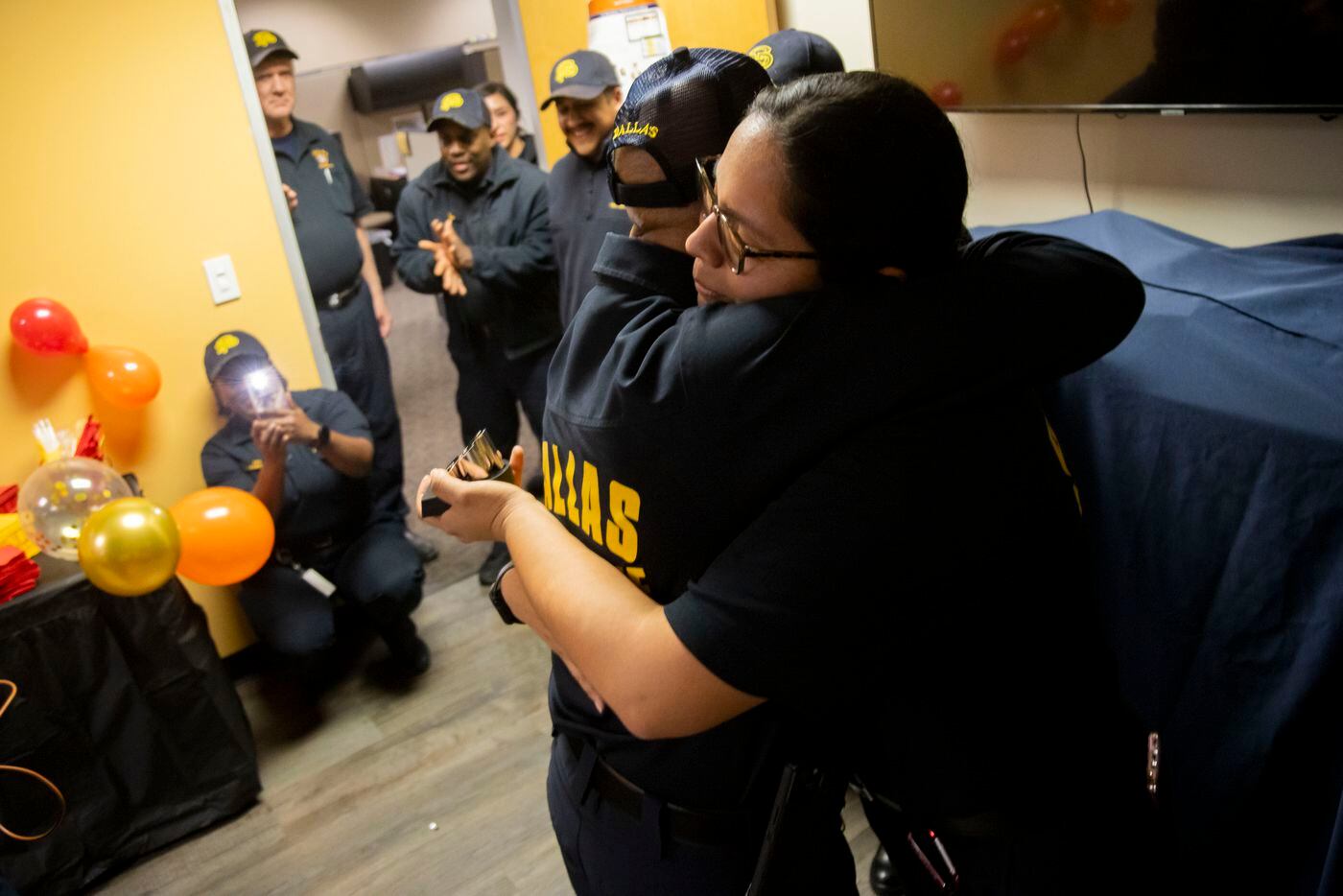 Fire prevention officer Clarence Briggs hugs fire prevention officer Gisell Delgado during a...