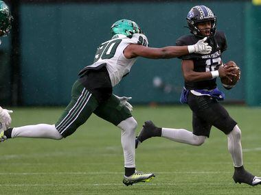 North Crowley quarterback Chris Jimerson (12) tries to avoid getting sacked by Prosper...