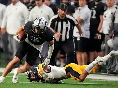 Denton Guyer wide receiver Sutton Lee (8) is brought down by Highland Park defensive back...