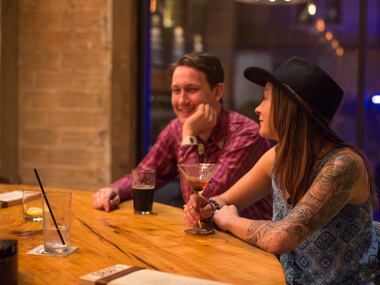 Dentonites Nathan West and Abby Chapman enjoy drinks at the bar during Barley and Board's...
