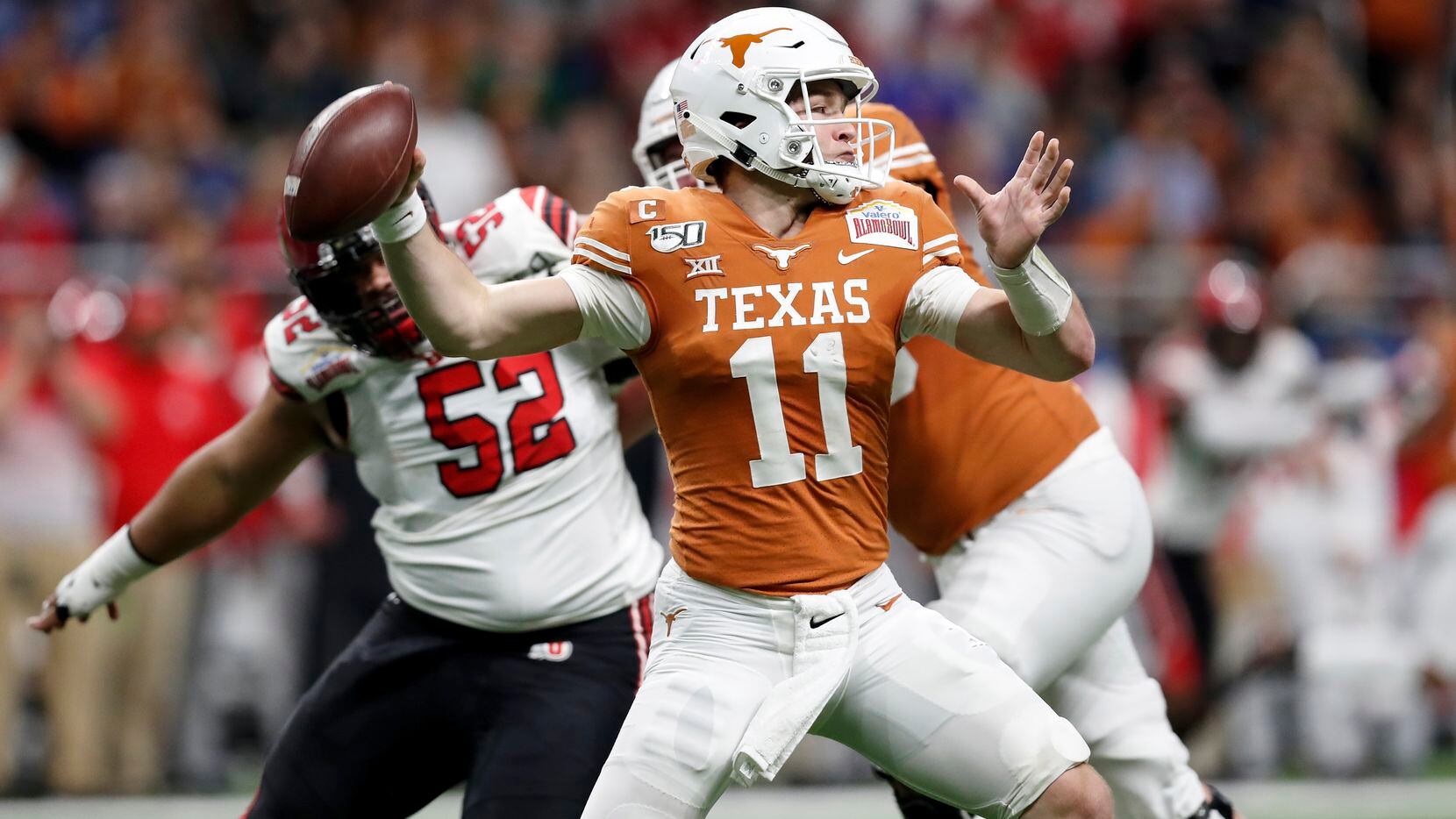 SAN ANTONIO, TX - DECEMBER 31:  Sam Ehlinger #11 of the Texas Longhorns throws a pass under pressure by John Penisini #52 of the Utah Utes in the first quarter during the Valero Alamo Bowl at the Alamodome on December 31, 2019 in San Antonio, Texas.  (Photo by Tim Warner/Getty Images)