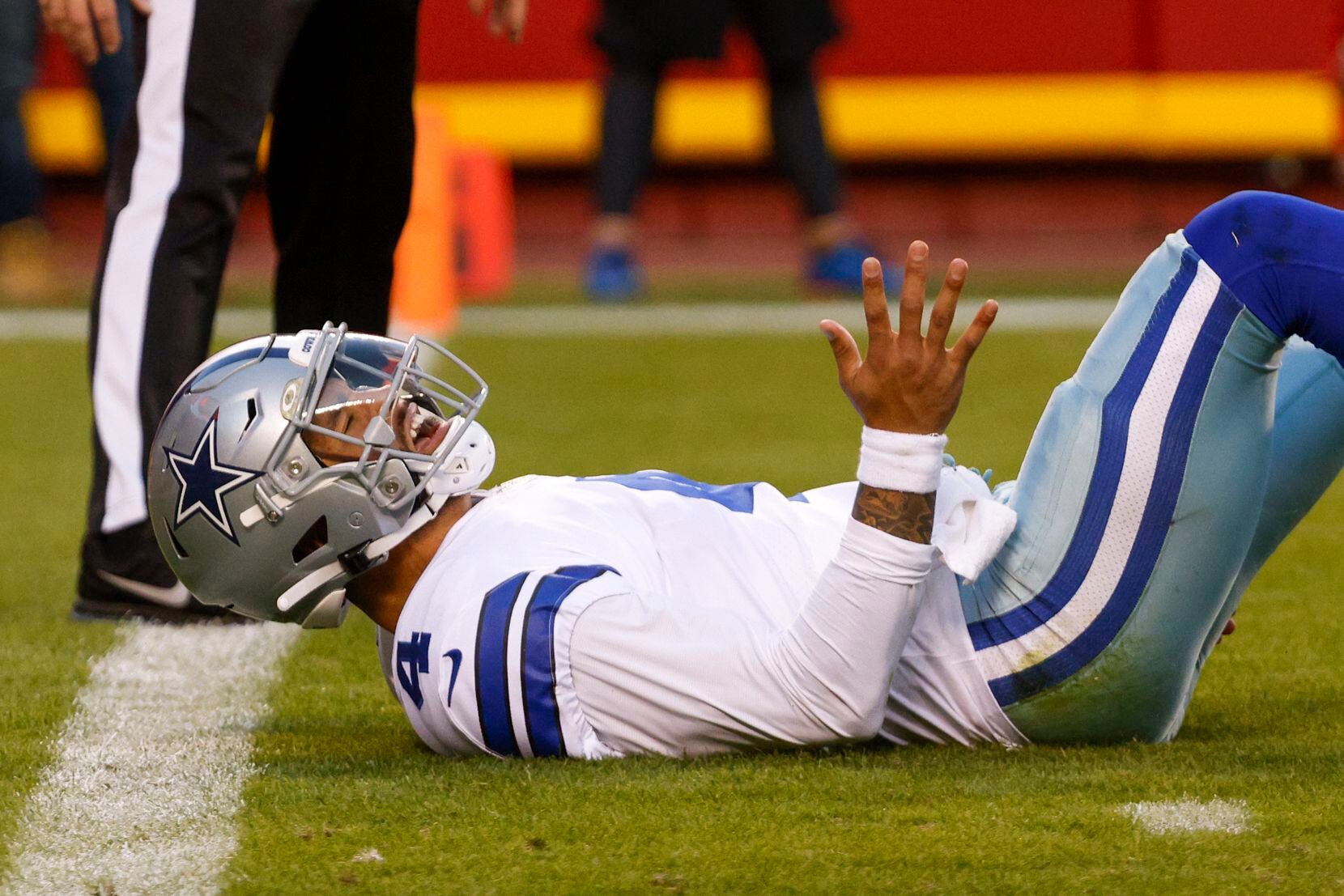 Dallas Cowboys quarterback Dak Prescott (4) reacts after being knocked to the ground by Kansas City Chiefs outside linebacker Nick Bolton (54) during the first half of an NFL football game against the Kansas City Chiefs at Arrowhead Stadium on Sunday, Nov. 21, 2021, in Kansas City, Missouri. (Elias Valverde II/The Dallas Morning News)