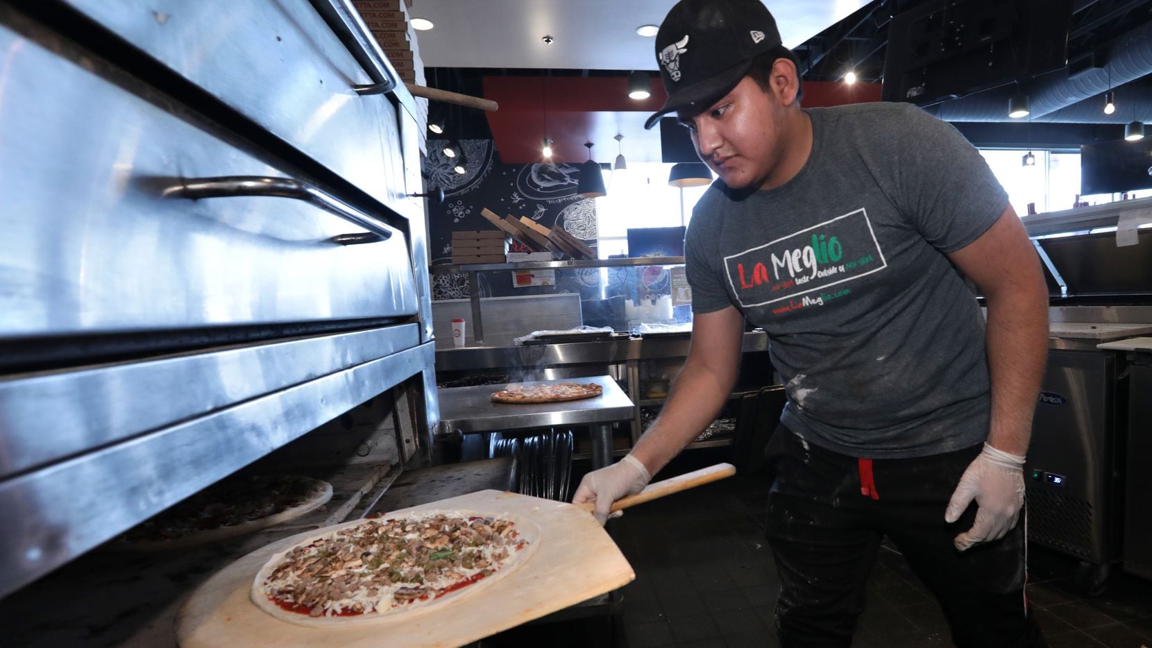 Juan José Orosco makes pizza at In-Fretta in Plano on April 2, 2020.
