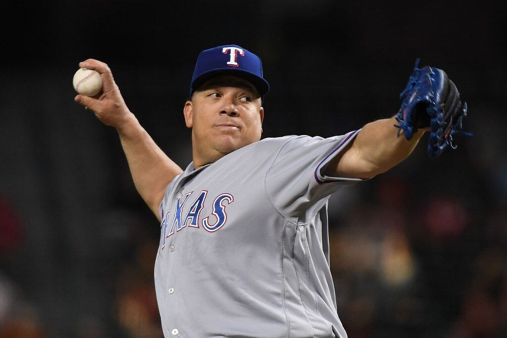 PHOENIX, AZ - JULY 31:  Bartolo Colon #40 of the Texas Rangers delivers a first inning pitch...