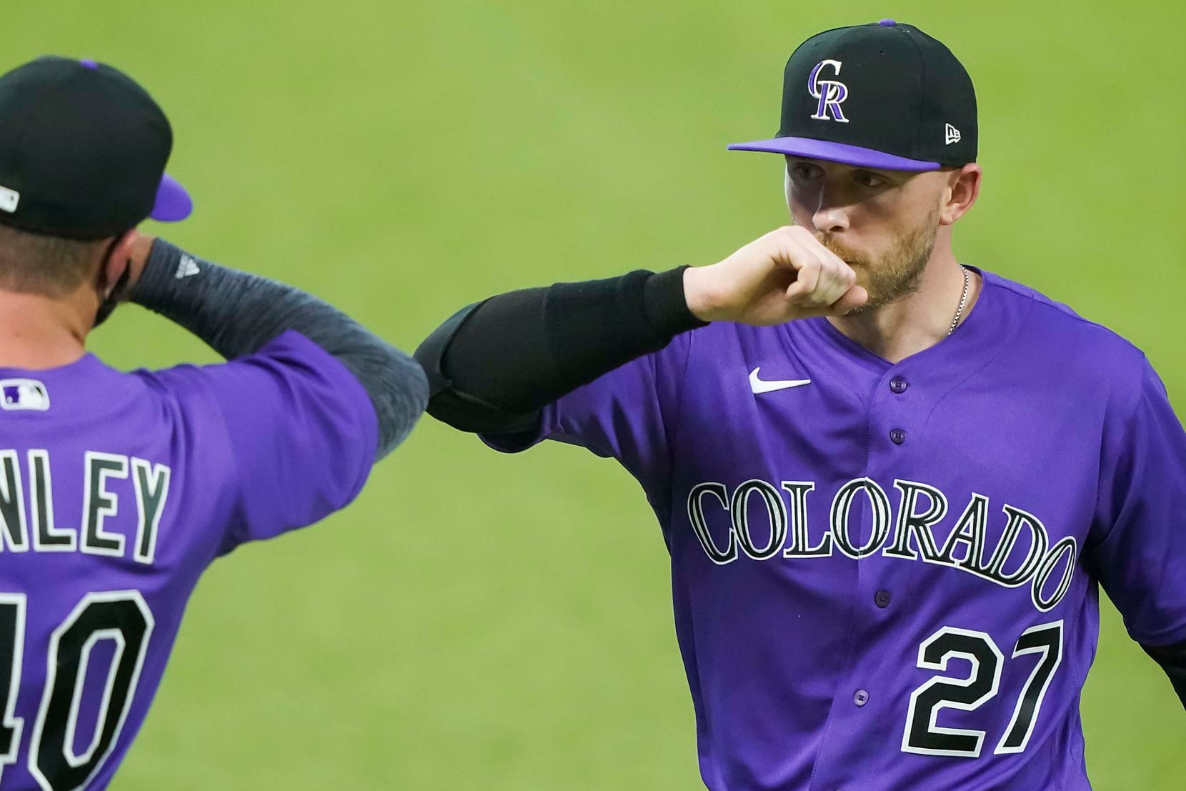 Colorado Rockies shortstop Trevor Story elbow bumps with teammate Bobby Bradley before an...