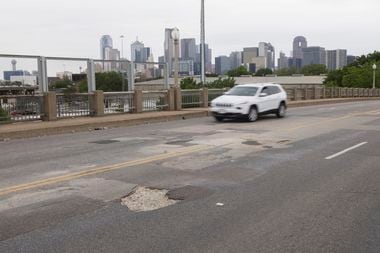 Vehicles drive over the Malcolm X Boulevard bridge on Friday, April 19, 2024, in Dallas....