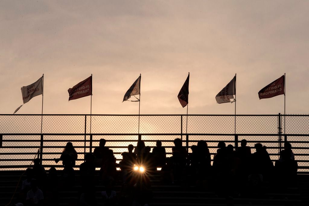 Flags fly as fans take their seats at Max Goldsmith Stadium before a high school football...