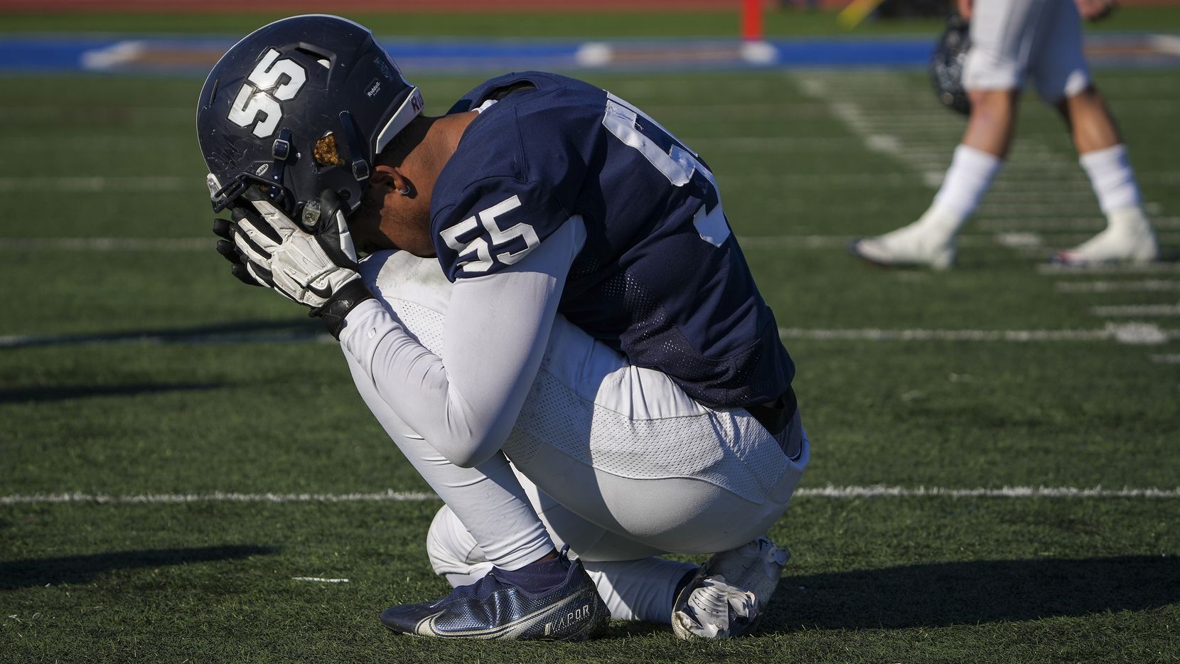Episcopal School of Dallas defensive lineman Justin McCray (55) kneels on the field after a...