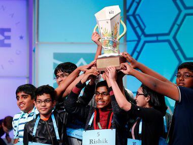 The eight co-champions celebrate after winning the Scripps National Spelling Bee, Friday,...
