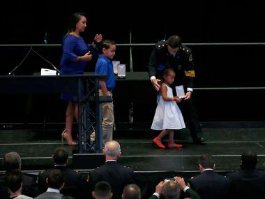 Lyncoln Zamarripa, daughter of slain officer Patrick Zamarripa, receives the Police Cross...