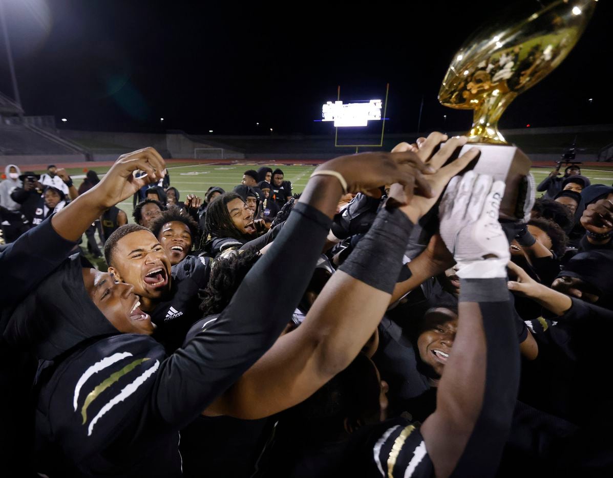 South Oak Cliff football players celebrate their win over Everman with the Class 5A Division...