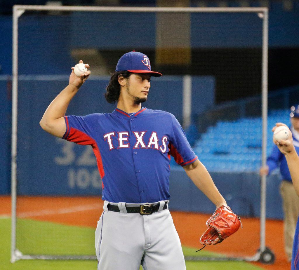 Texas Rangers starting pitcher Yu Darvish loosens up before the Texas Rangers vs. Toronto...