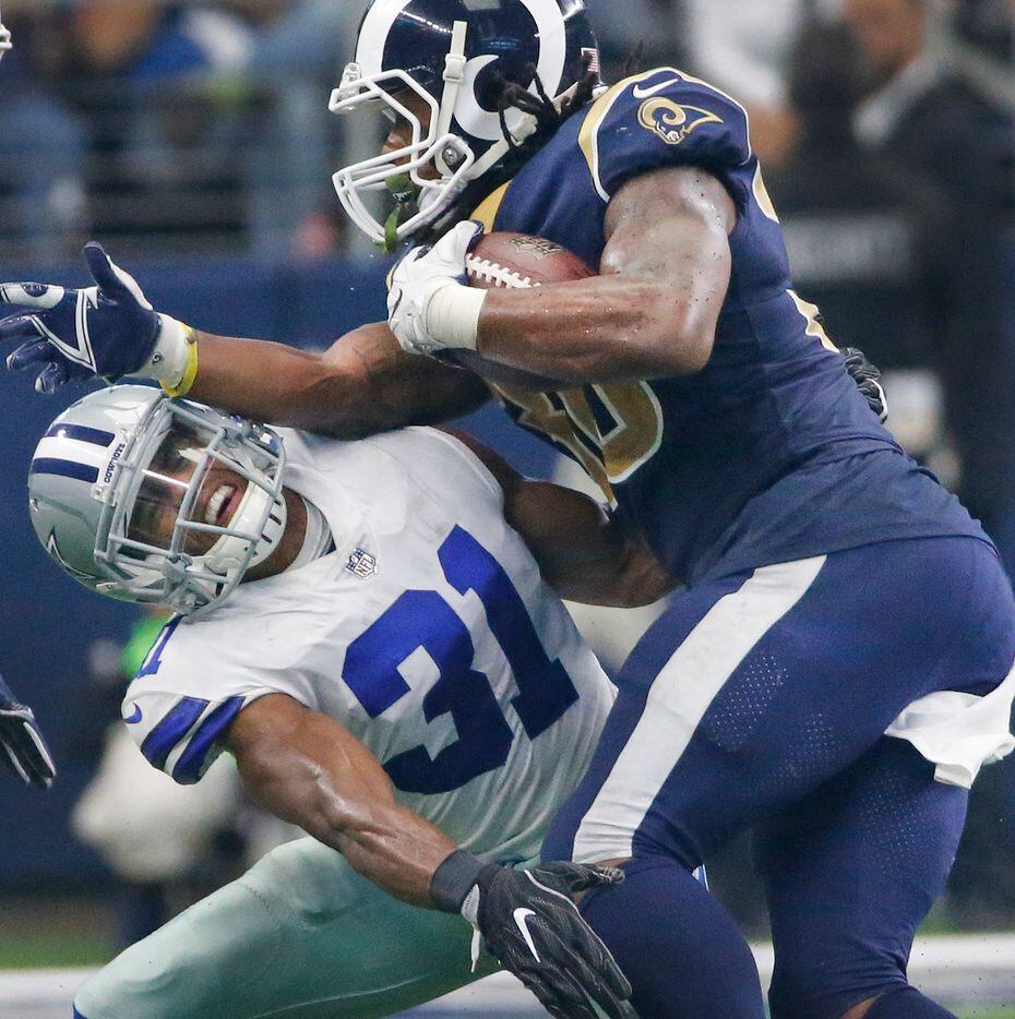 Dallas Cowboys free safety Byron Jones (31) takes a forearm from Los Angeles Rams running...