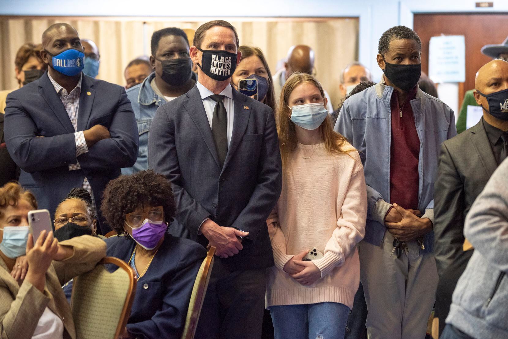 Dallas County Judge Clay Jenkins, wearing a Black Lives Matter mask, stands next to his daughter Madeleine Jenkins as they listen to U.S. Rep. Eddie Bernice Johnson announce that she will retire from Congress during “The Justice Tour" luncheon for Democratic Party activists and judicial candidates, at Kirkwood Temple CME Church in Dallas, on Saturday, Nov. 20, 2021. 