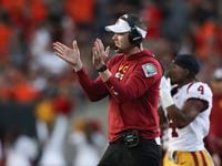 Southern California coach Lincoln Riley applauds during the first half of the team's NCAA...