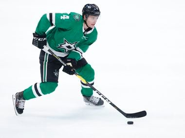Dallas Stars defenseman Miro Heiskanen (4) will try to pass the puck against the Carolina Hurricanes in the first period at the American Airlines Center in Dallas on Tuesday, April 27, 2021.